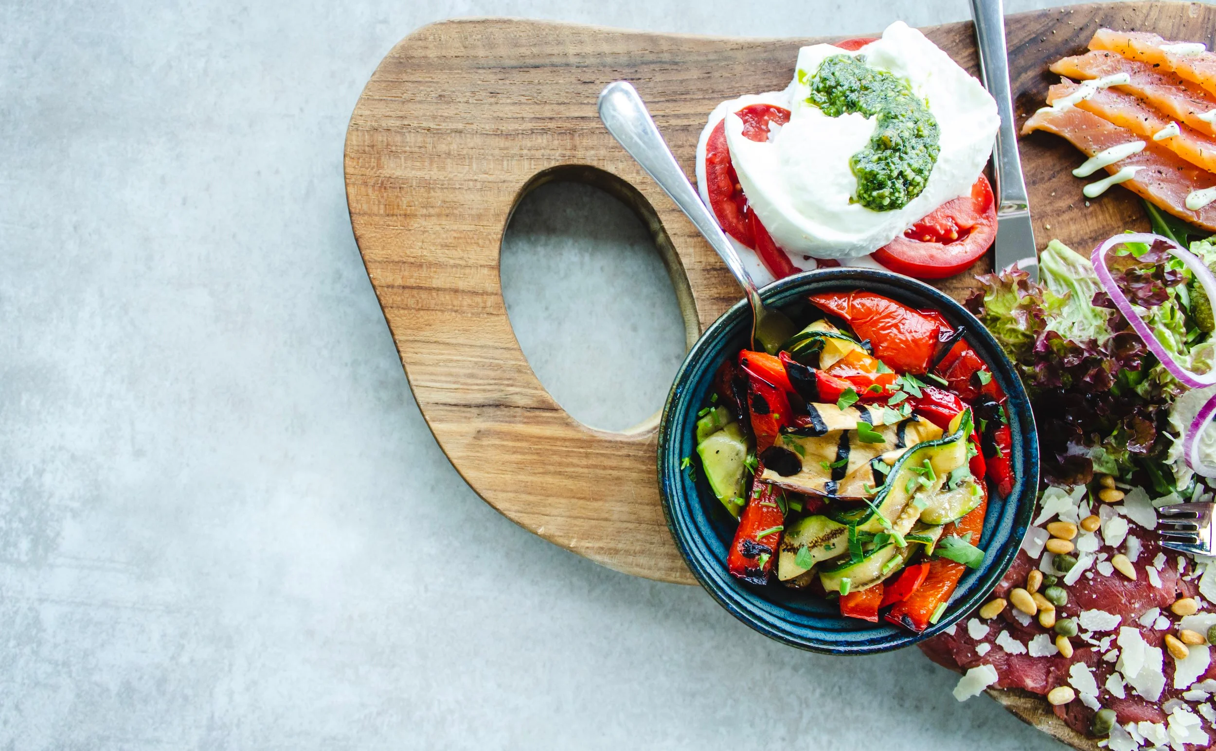 Healthy and nutritious meal spread arranged on a wooden board for members of Feel Good Fitness.